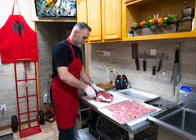Butcher cutting fresh meat